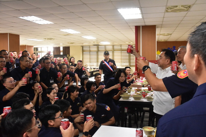 The Principal joins the new students in raising a toast to celebrate during the 'Assessment Passed, Congratulations' event